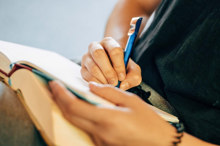 Picture of a person taking notes